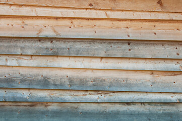 a wall of boards of different colors. wooden colored background