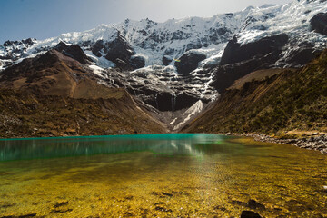 laguna humantay with snow covered mountains in the background