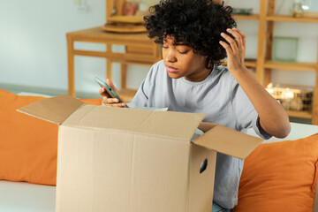 Unhappy african woman unpack delivered box receiving damaged shipping problem in postal service....