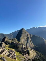 world heritage site Machu Picchu in Peru at sunrise with sunrays on the mountain