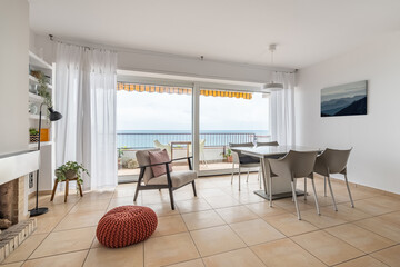 Dining table with chairs near terrace with panoramic window