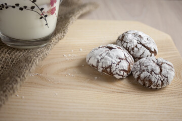 Chocolate brownie cookies close-up and milk in a cup. Homemade baking, sweet dessert.