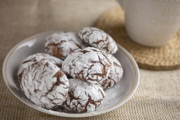 Chocolate brownie cookies close-up and milk in a cup. Homemade baking, sweet dessert.