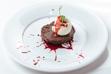 chocolate dessert with ice cream on a plate on a white background