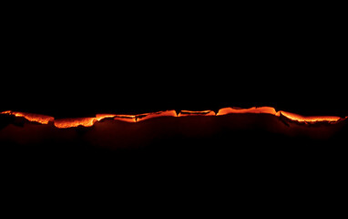 burning paper, glowing edge of paper on a black background