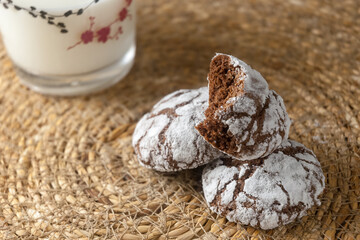 Chocolate brownie cookies close-up and milk in a cup. Homemade baking, sweet dessert.