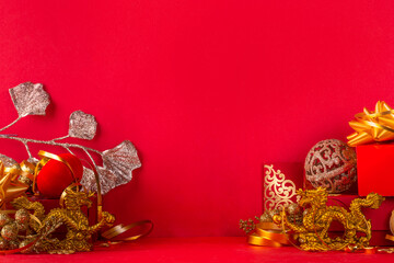 Chinese New Year 2024 greeting card. Bright red asian year of the dragon background with golden dragon figurine, Chinese lanterns, traditional jewelry, gifts, coins, cookies with wishes, copy space