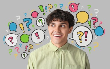 Young man and many speech bubbles with question and exclamation marks on grey background