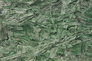 green chipboard closeup.wooden detailed background with sawdust and shavings. Seamless compressed wood particle board background texture. 