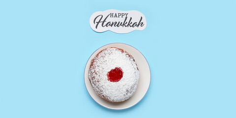 Tasty donut and text HAPPY HANUKKAH on light blue background