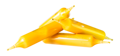 Clipping of phials or ampoules stacked containing a golden supplement based on royal jelly rich in amino acids, vitamins, minerals, trace elements helping body to strengthen immunity.