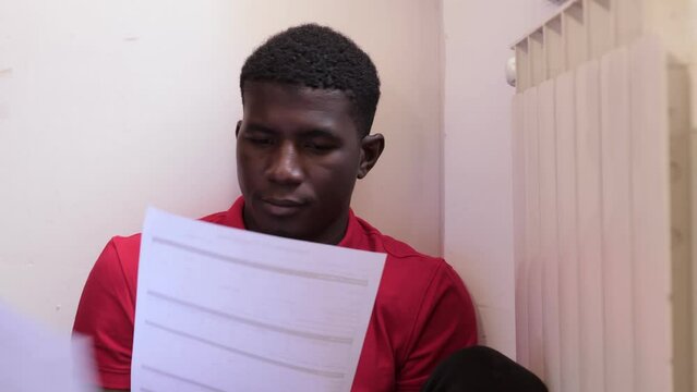 portrait of exhausted young african man shaking his head from the forms to fill out