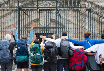 Pilgrims from the Camino de Santiago arrive at the Plaza del Obradoiro because they have finished...