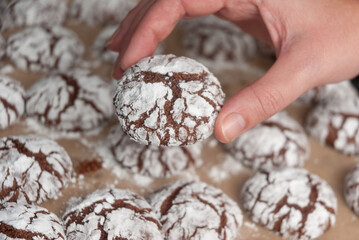 A woman's hand holds a chocolate cookie.Homemade baking close-up.