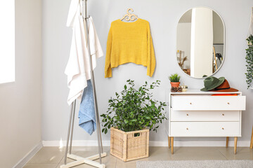 Stylish interior of light room with clean towels and clothes