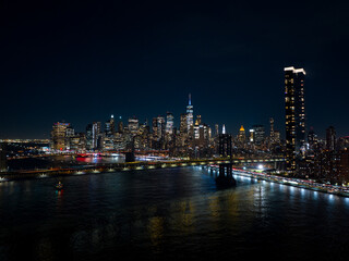 Night aerials New York City. View of river and bridges lit