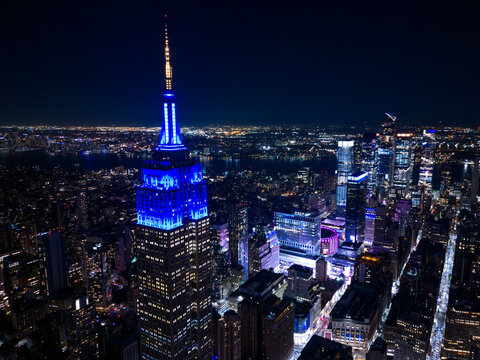 Aerial photo Empire State Building lit blue at night