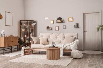 Interior of light living room with couch and coffee table - obrazy, fototapety, plakaty