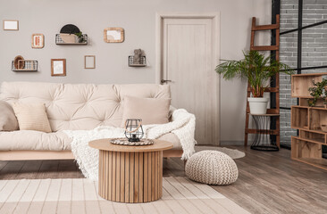 Interior of light living room with couch and coffee table