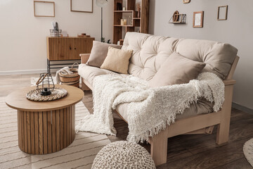Interior of light living room with couch and coffee table