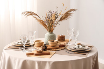 Elegant table setting with dried flowers, pampas grass and pine cones