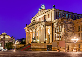 Fototapeta na wymiar Concert Hall (Konzerthaus) and New Church (Deutscher Dom or Neue Kirche) on Gendarmenmarkt square at night in Berlin, Germany
