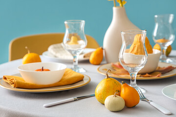 Autumn table setting with pumpkins and wine glasses, closeup