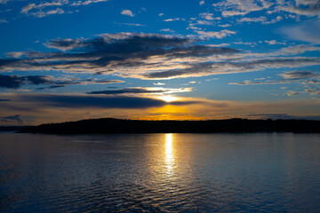 Sun setting over an island.