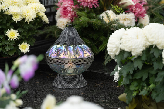 Lantern and flowers on the grave on All Saints' Day
