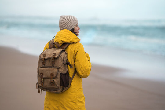 Beautiful woman traveler enjoying autumn hiking at the seaside. Active lifestyle