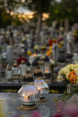 Lanterns on the grave on All Saints' Day and the cemetery in the background.