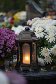 Lantern and chrysanthemum on the grave on All Saints' Day