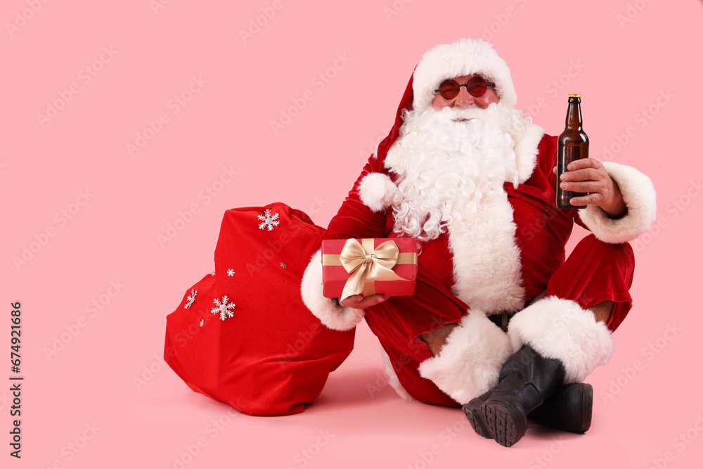 Sticker santa claus with beer and bag of gifts on pink background