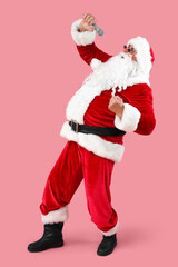 Cool Santa Claus with microphone singing on pink background