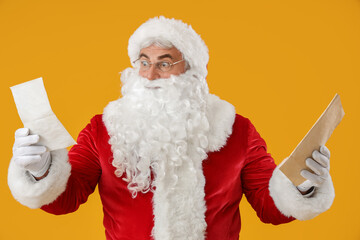 Shocked Santa Claus with letters on yellow background