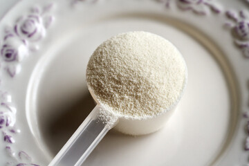 Collagen powder in a measuring spoon