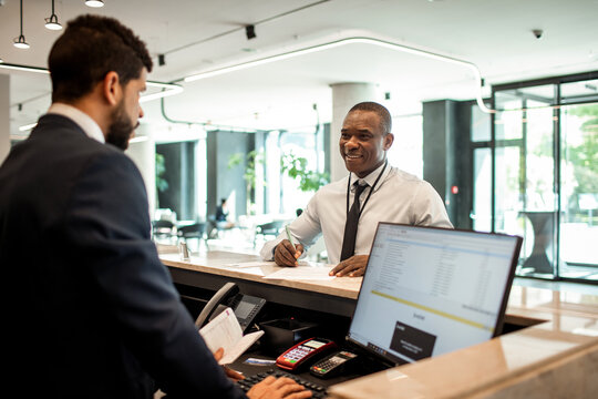 Mature man doing check in at hotel reception
