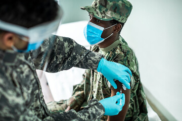 Nurse vaccinating a soldier at the hospital