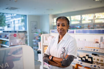 Senior female pharmacist looking at camera in pharmacy
