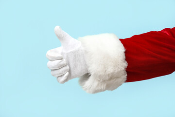 Santa Claus showing thumb-up on blue background