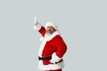 Fototapeta na wymiar Dancing Santa Claus on grey background