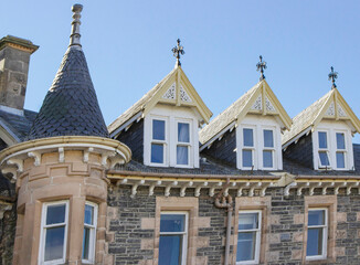 Fototapeta na wymiar Roof and attic windows on a ornate Scottish building