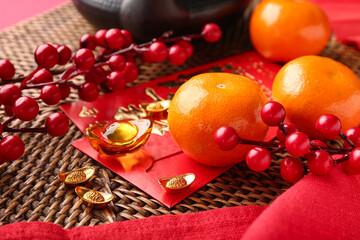 Teapot with mandarins, envelopes and oriental symbols on red background. New Year celebration