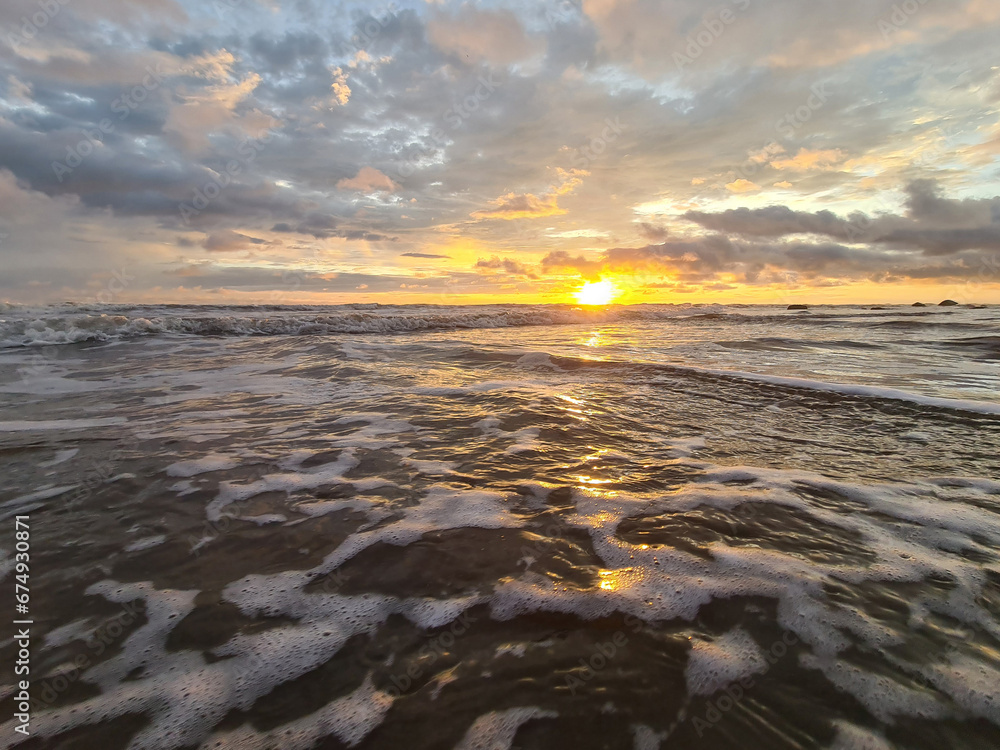 Poster low sun over ocean water