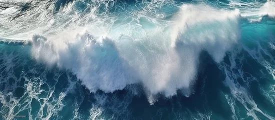 Fotobehang Beautiful texture of big power dark ocean waves with white wash. Aerial top view footage of fabulous sea tide on a stormy day. Drone filming breaking surf with foam in Indian ocean. Big swell in Bali. © haizah