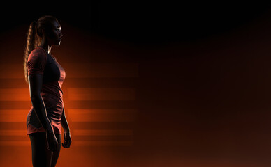 photorealistic image of a silhouette of a volleyball player standing with a profile on the left side of the image, dramatic lighting, space for text