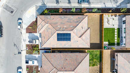 Top Down view of a house with a solar panel on it and a empty backyard