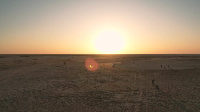 Low drone flight in a salt desert with a sunset. Drone flies forward at low level. General plane