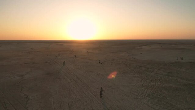 Low drone flight in a salt desert with a sunset. Drone flies forward at low level. General plane