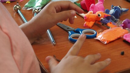 Little girls sculpt figurines crafts from air plasticine, modeling dough. Online lessons in tablet....